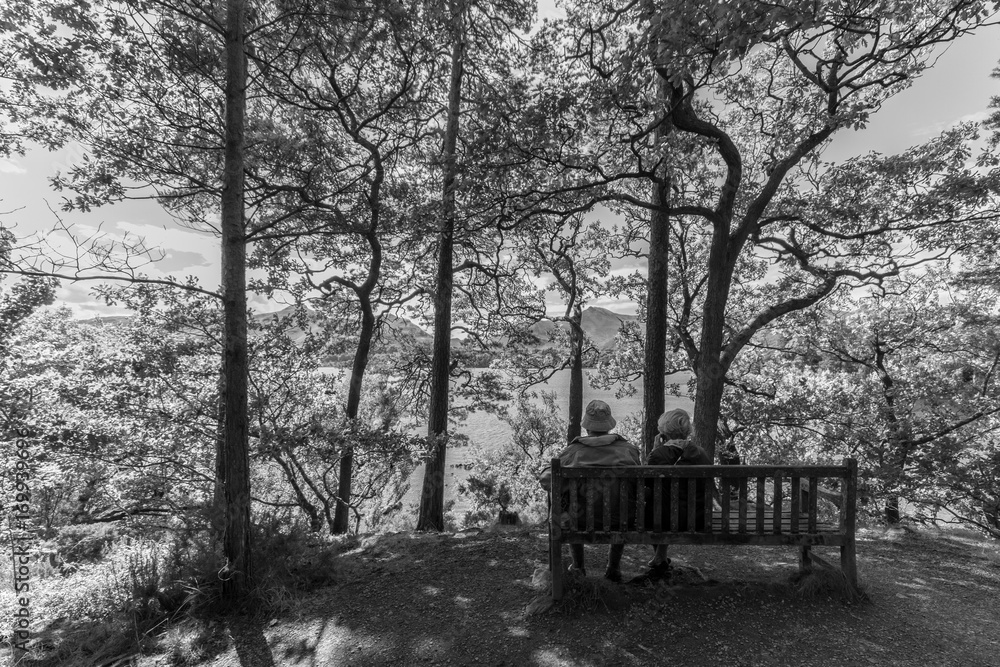 Old couple on bench, Derwent Water lake, Keswcik, UK- monochrome