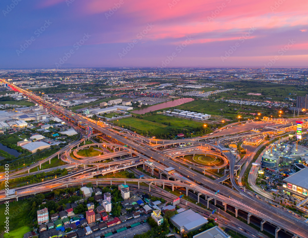 Fototapeta premium Bangkok Expressway top view, Top view over the highway,expressway and motorway at night, Aerial view interchange of a city, Shot from drone, Expressway is an important infrastructure in Thailand