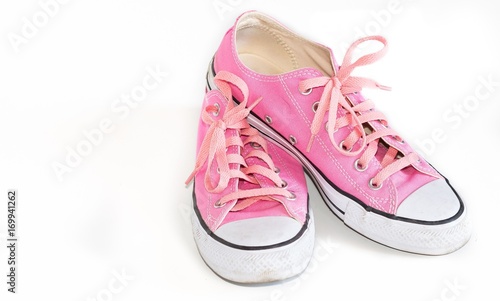 Used pink shoes on a white background