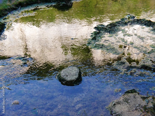Détail d'une pierre et reflet du cirque de Baume dans l'eau © CHRISTINE