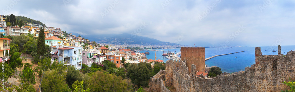 Panoramic view of Alanya harbor and ancient stone wall of Alanya Castle. Alanya, Turkey