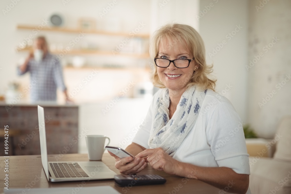 Senior woman using mobile phone at home Senior woman using mobile phone at home