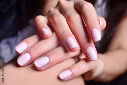 Beautiful white manicure, soft young hands, fashion