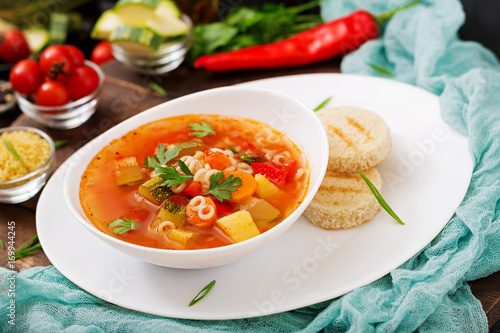 Minestrone - "big soup", soup with many ingredients - a dish of Italian cuisine, light seasonal vegetable soup with pasta.