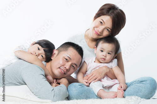 Young happy Asian family with kids