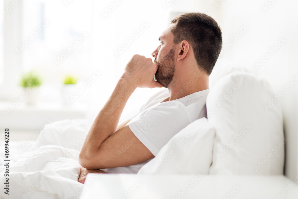 stressed man in bed at home stressed man in bed at home