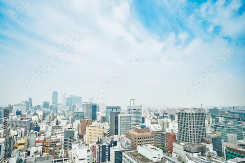 Business concept - panoramic modern city skyline bird eye aerial view with spiral tower and midland square under dramatic cloud and morning bright blue sky on Nagoya TV Tower in Nagoya  Japan