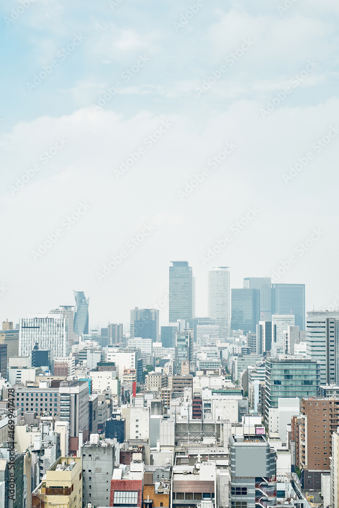 Business concept - panoramic modern city skyline bird eye aerial view with spiral tower and midland square under dramatic cloud and morning bright blue sky on Nagoya TV Tower in Nagoya, Japan