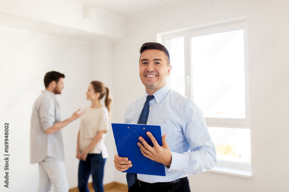 realtor with clipboard and couple at new home