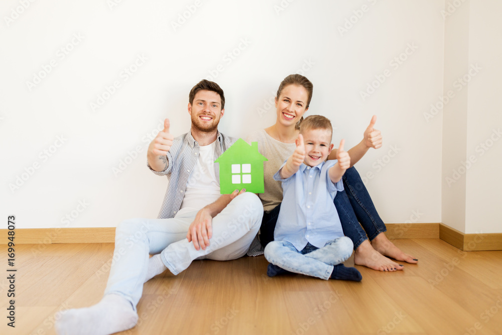 family with green house showing thumbs up at home family with green house showing thumbs up at home