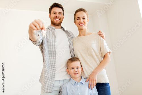 happy family with key moving to new home