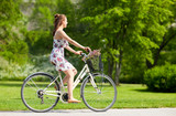happy woman riding fixie bicycle in summer park