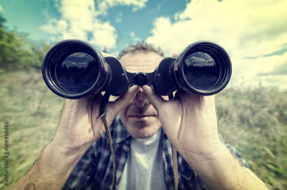 Man looking through binocular Man looking through binocular