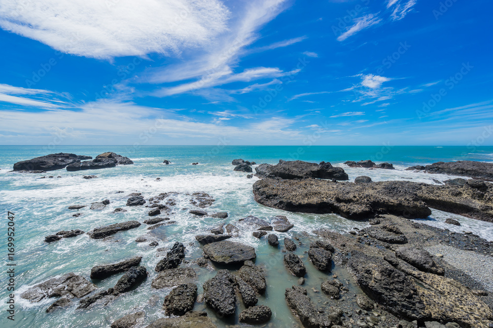 Panoramic view of beautiful sea level with reef rocks under fantasy blue cloudy and sunshine sky in Sansiantai Taitung, Taiwan