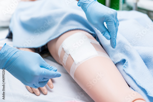 Nursing student were trained how to wound care patient. She practice training with the Doll of patient, Before treatment to the real patient.