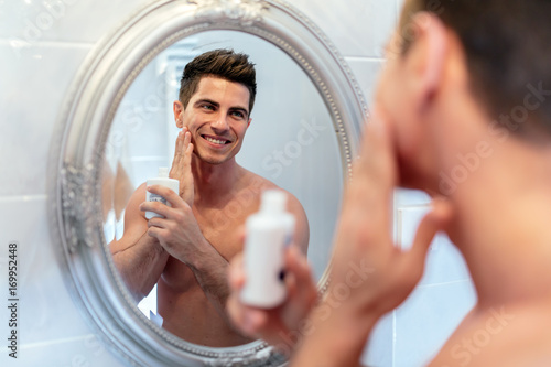 Happy handsome man shaving photo