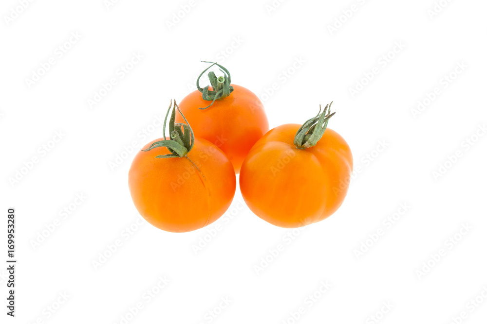 three small orange tomatoes on a white background three small orange tomatoes on a white background