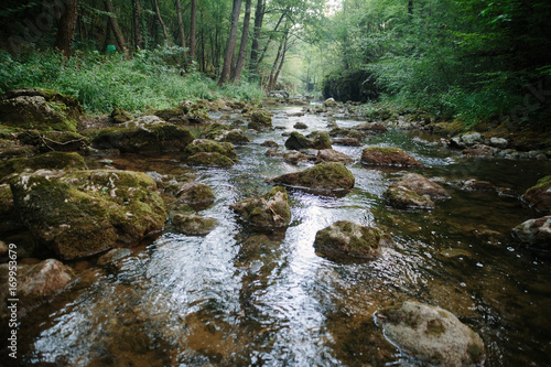 Mountain river flowing through woods, over the rocks. Moravica, Soko Banja, Serbia. photo