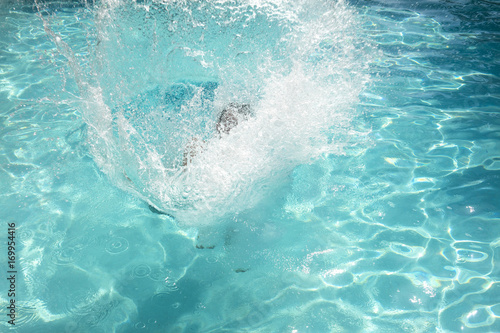 View of big splash in swimming pool photo