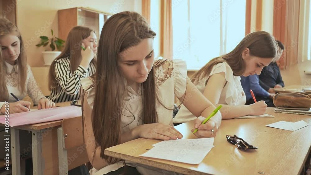 Russian school. Pupils write a control exam in their notebooks. Russian school. Pupils write a control exam in their notebooks.