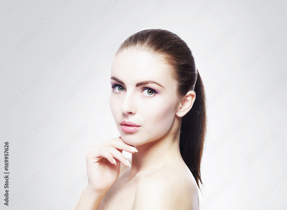 Portrait of young, beautiful and healthy woman: over cold grey background. Healthcare, spa, makeup and face lifting concept. Portrait of young, beautiful and healthy woman: over cold grey background. Healthcare, spa, makeup and face lifting concept.