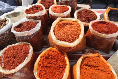 Many types of dried under sunlight red hot chilli pepper Turkish Maras biberi in an open air market photo