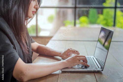 Young businesswoman working with laptop in cafe