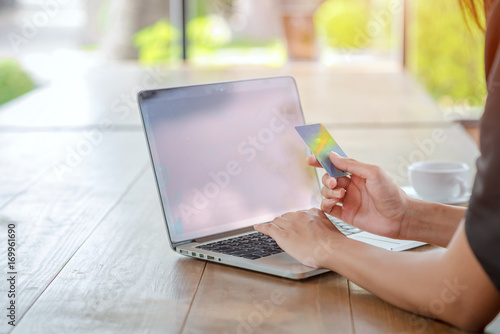 Businesswoman holding credit card, shopping online