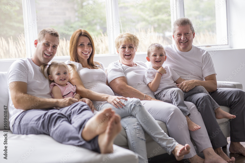 family, happiness, generation and people concept on the sofa