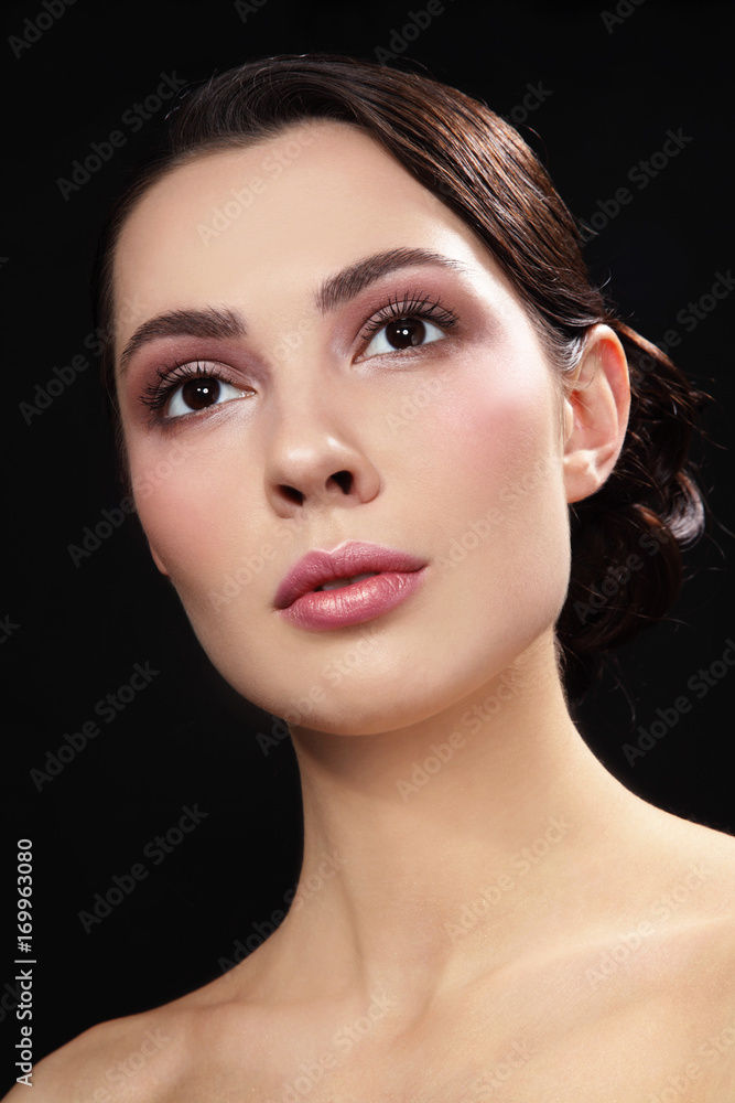Portrait of young beautiful woman with stylish make-up looking upwards Portrait of young beautiful woman with stylish make-up looking upwards