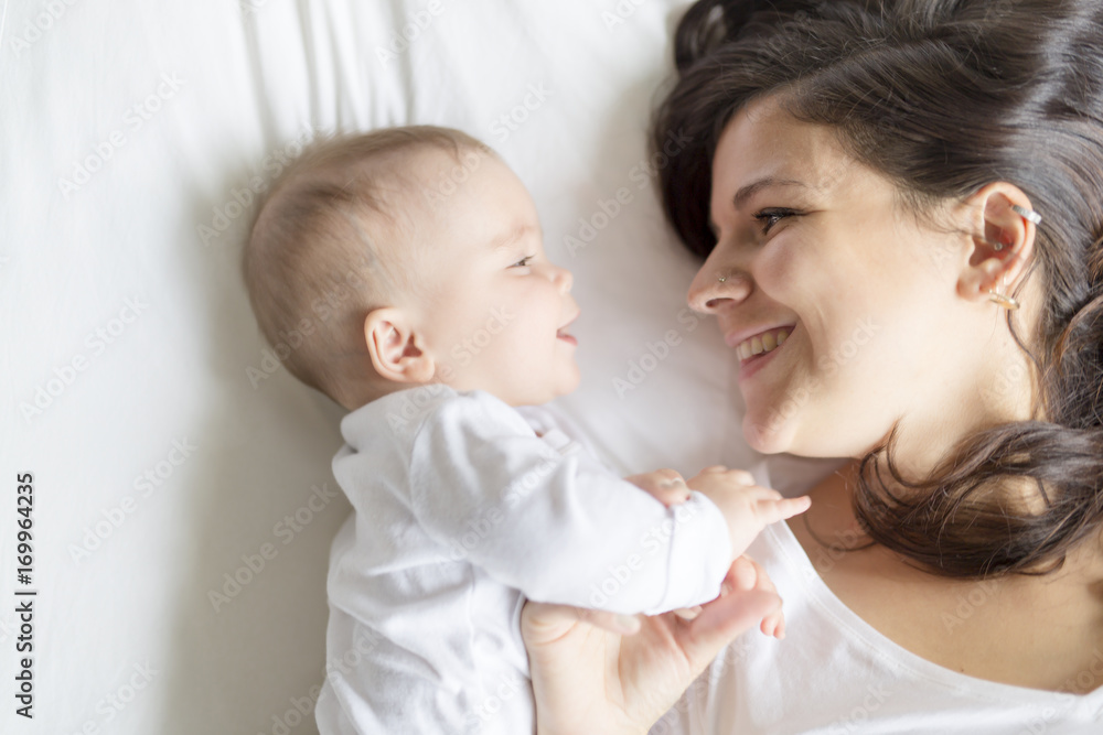 happy loving family. mother playing with her baby in the bedroom. happy loving family. mother playing with her baby in the bedroom.
