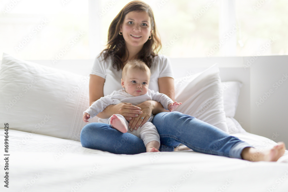 happy loving family. mother playing with her baby in the bedroom. happy loving family. mother playing with her baby in the bedroom.