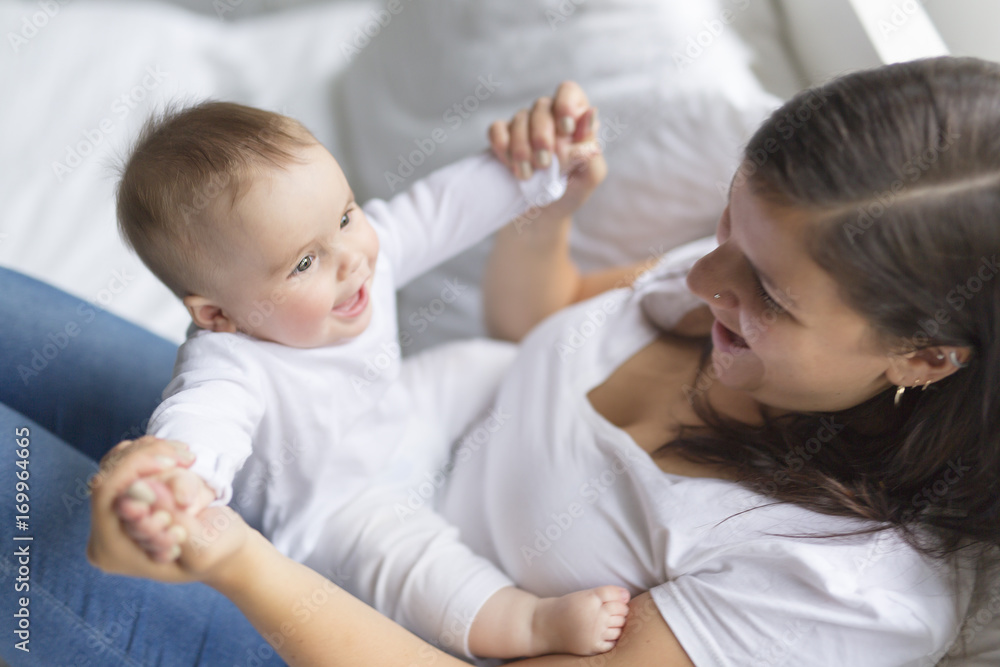 happy loving family. mother playing with her baby in the bedroom. happy loving family. mother playing with her baby in the bedroom.