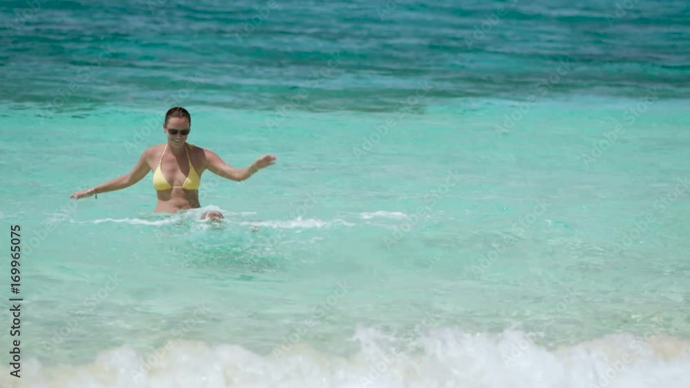 slow motion video of mother and child splashing in tropical water. slow motion video of mother and child splashing in tropical water.