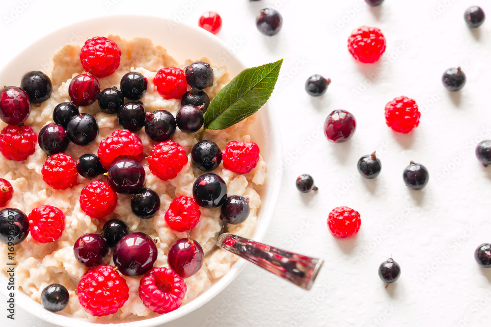 Milk oat porridge with forest berries close-up Milk oat porridge with forest berries close-up