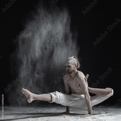 Flexible yoga man doing hand balance asana brahmachariasana. © Viktor Koldunov