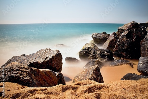 Sea waves and rocks on the beach in Malgrat de Mar, Spain. photo