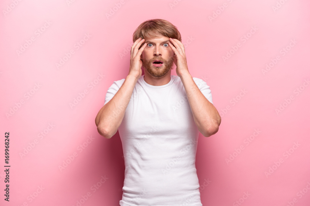 Portrait of young man with shocked facial expression Portrait of young man with shocked facial expression