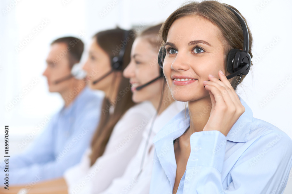 Call center operator in headset while consulting client. Telemarketing or phone sales. Customer service and business concept Call center operator in headset while consulting client. Telemarketing or phone sales. Customer service and business concept
