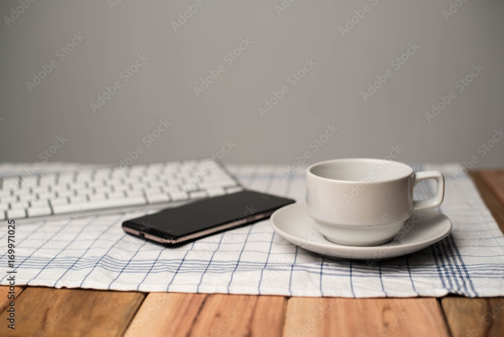 Business concept. Office supply on desk table with cup of coffee and analysis chart, smartphone, keyboard, notebook, on desk.