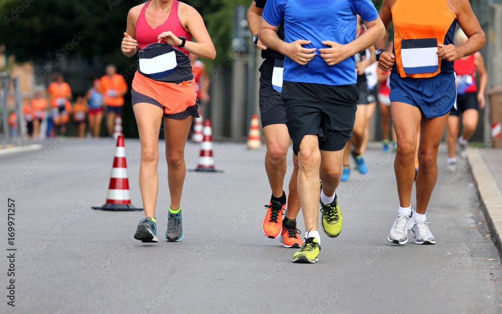 runners run with shorts and sneakers along the streets of the ci