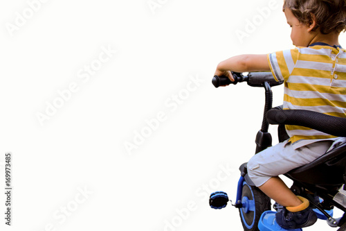 a little boy drives his bicycle