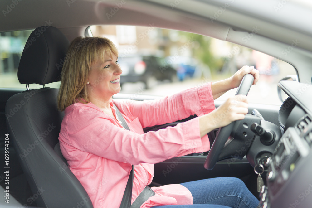 Happy and smiling senior woman in black car Happy and smiling senior woman in black car