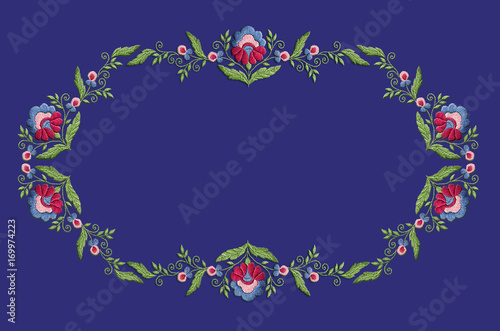 Frame pattern for embroidery a wreath with stylized flowers and leaves on a violet background