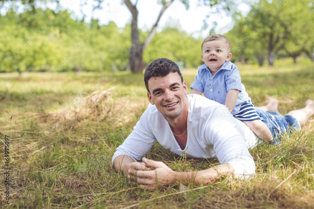 beautiful father little toddler son on the meadow. beautiful father little toddler son on the meadow.
