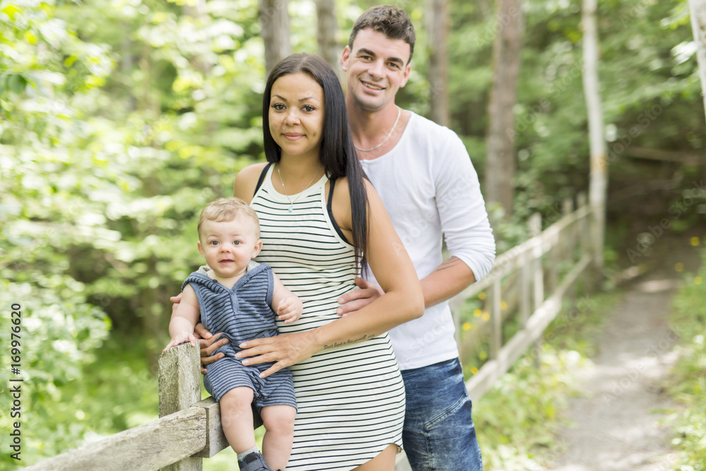 Happy Family Having fun with baby playing In The Park. Happy Family Having fun with baby playing In The Park.