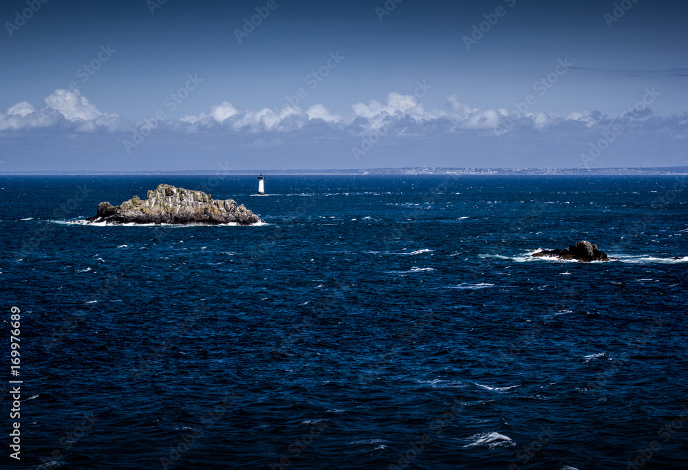 Sea, rock and lighthouse
