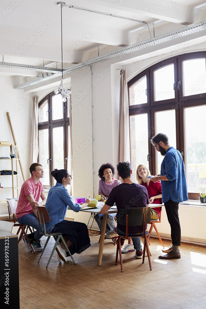 Designers Having Discussion At Conference Table Designers Having Discussion At Conference Table