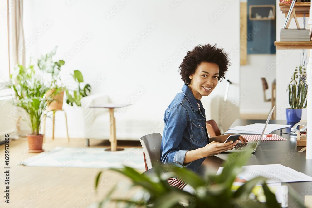 Happy Businesswoman Using Technologies In Creative Office Happy Businesswoman Using Technologies In Creative Office