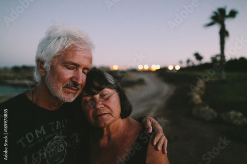 Couple of seniors on the road in twinlight